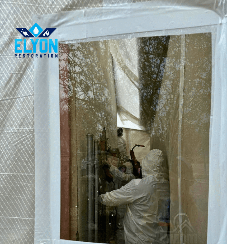 Professional asbestos removal team in protective gear working on Boulder Colorado project