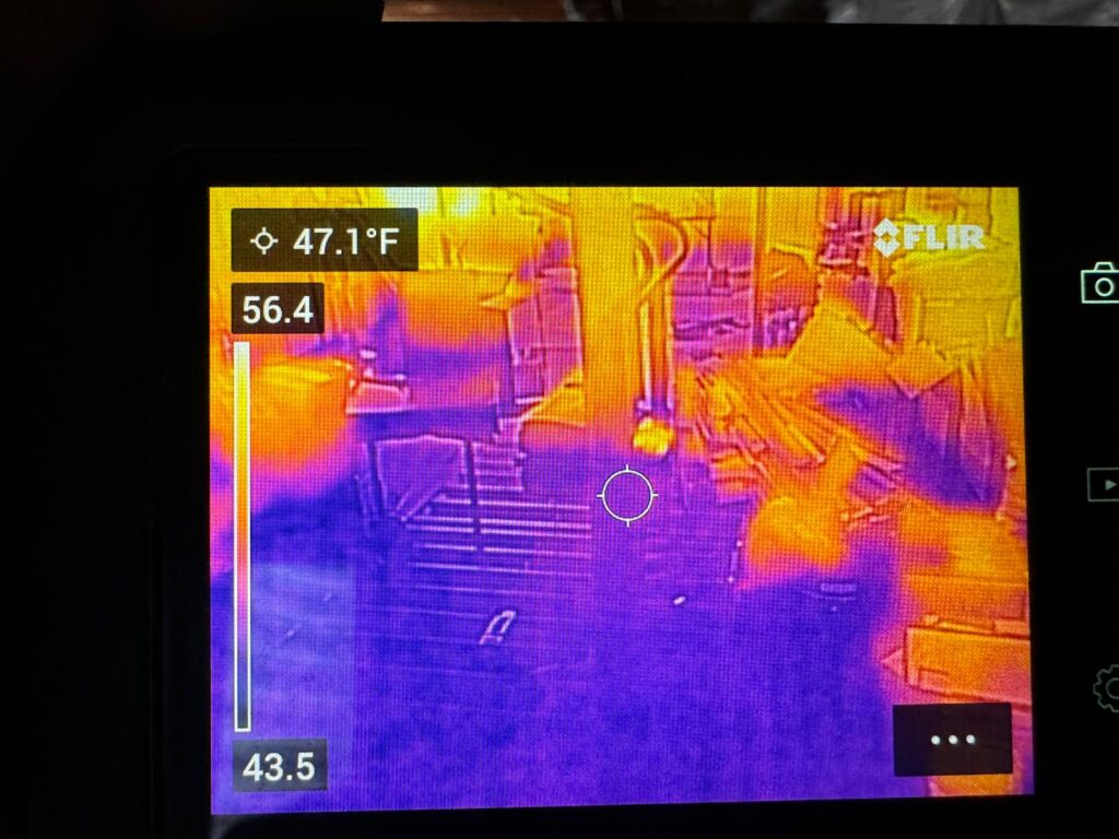 Thermal imaging display showing temperature variations in a basement, indicating potential hidden moisture and water damage, relevant for basement flooding prevention in Denver homes.