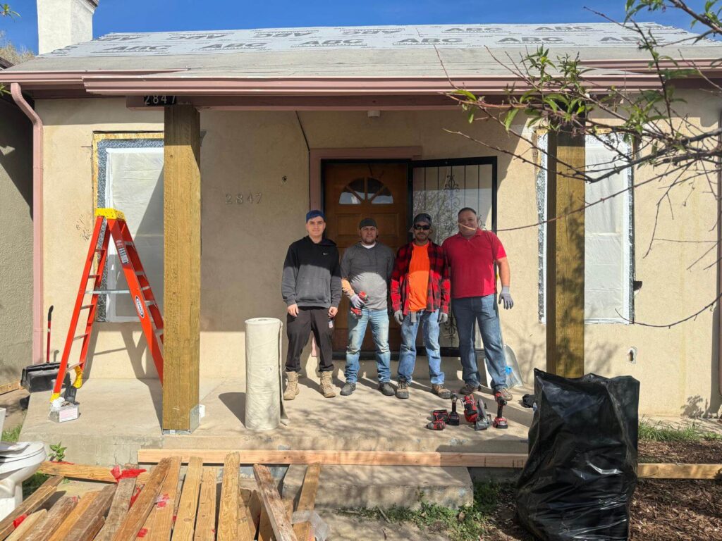 Experienced asbestos removal crew posing after completing Denver Colorado residential project